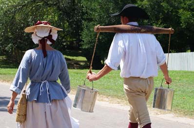 Man and Woman in Colonial Dress Walking