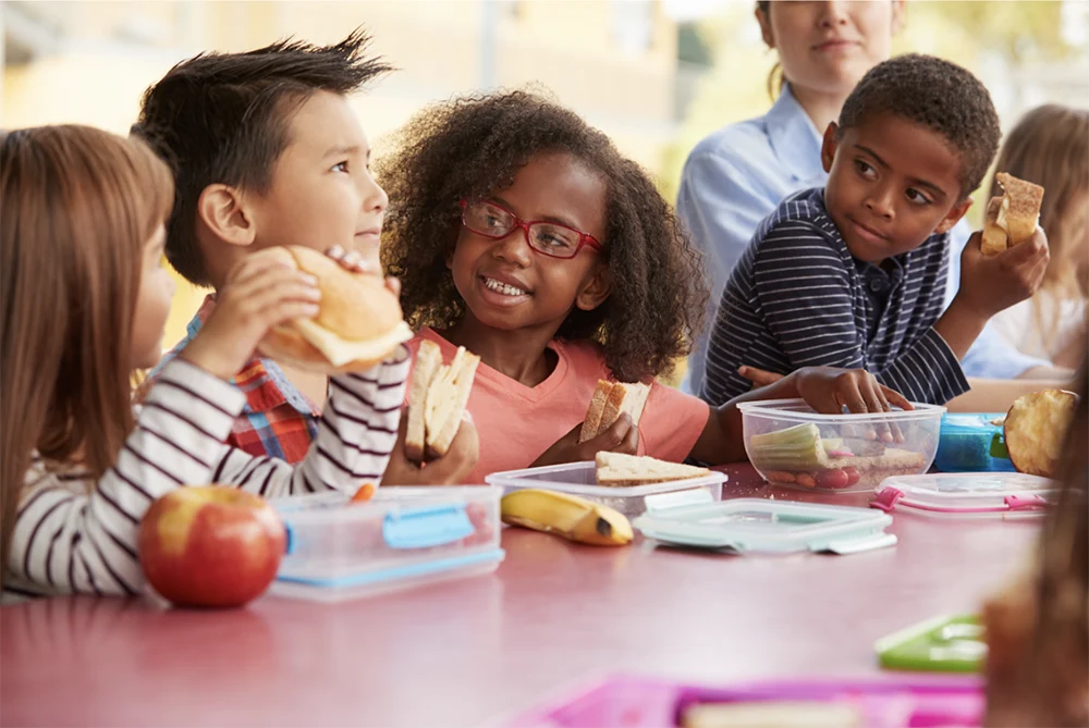 Kids smiling at lunch table